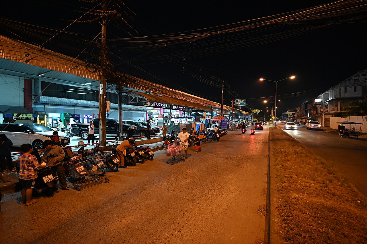 Night market storefront strip with scooters in Vietnam's small shop economy