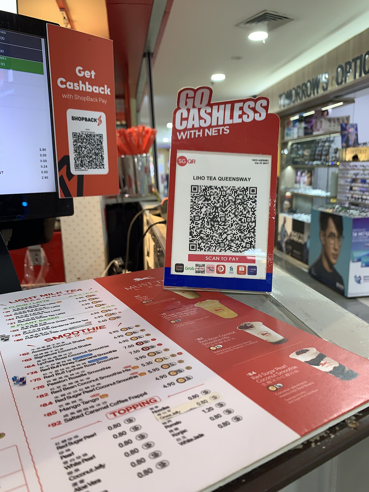 QR code payment at a small retail counter, digital payments feeding e-invoice data